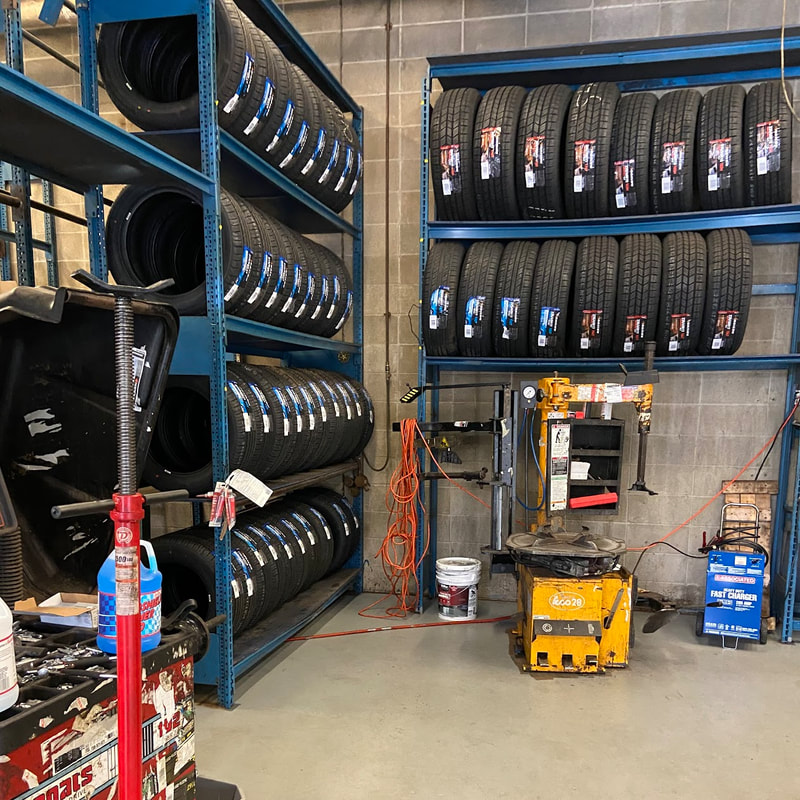 Tire alignment bay outfitted with shelves of new tires